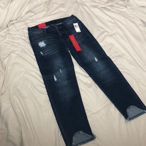 Medium to dark color minimal ripped jeans